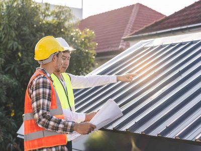 Builders looking at a metal roof