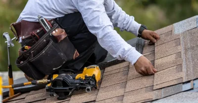 Roofer installing asphalt / composition shingles on a roof