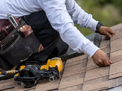 Roofer installing asphalt / composition shingles on a roof