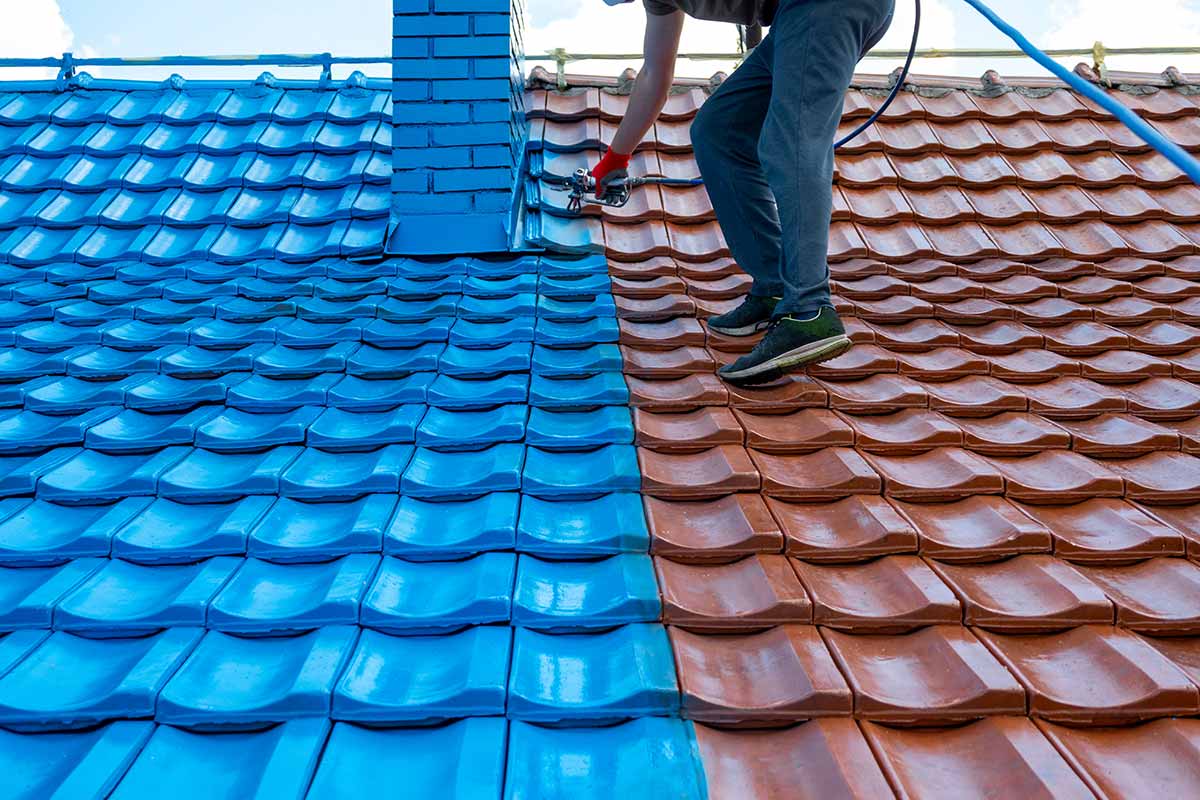 A tile roof being painted