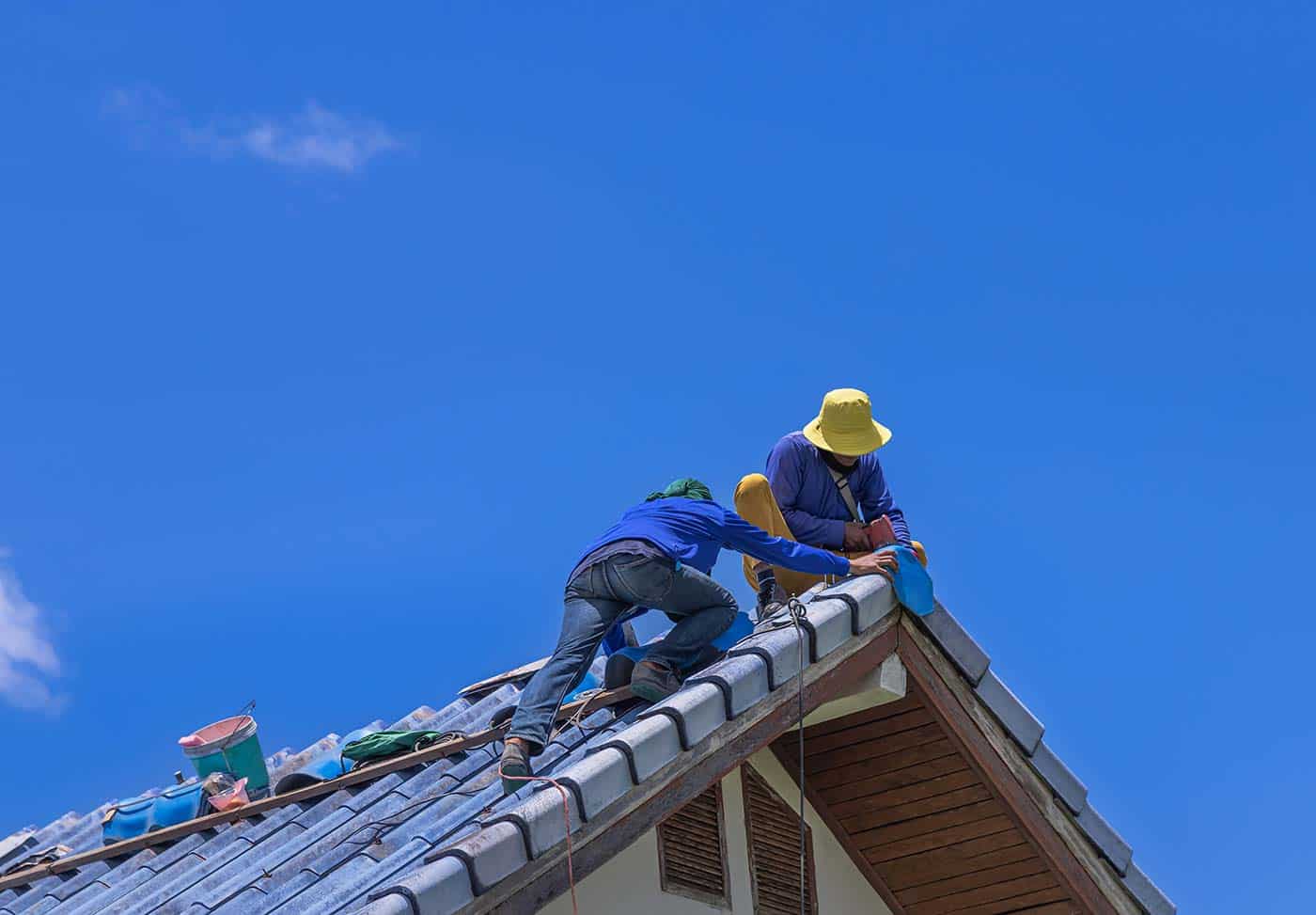 Roofers installing tile on a roof